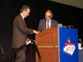 Dr. Douglas K. Rex prepares to deliver the inaugural Emily Couric Lectureship. He is welcomed to the podium by Dr. David A. Johnson, ACG President